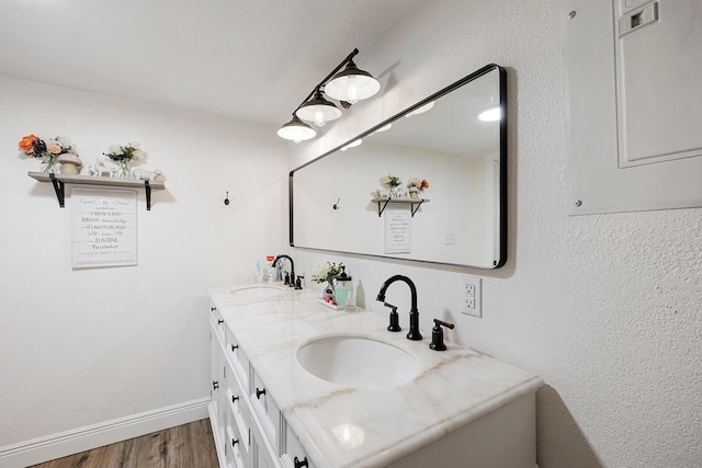 214 Rudolph St, Seymour, MO 65746 - bathroom with wood finished floors, double vanity, electric panel, and baseboards