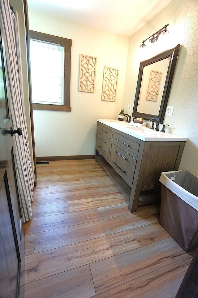 20770 State Highway 76, Cassville, MO 65625 - full bathroom featuring double vanity, wood finished floors, and baseboards