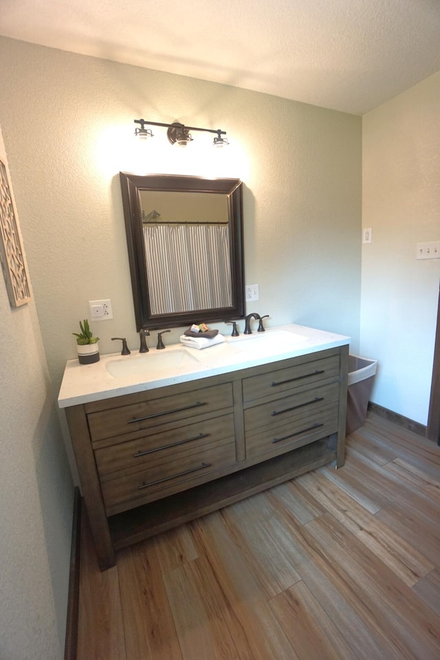 20770 State Highway 76, Cassville, MO 65625 - full bathroom with double vanity, wood finished floors, a textured wall, and toilet