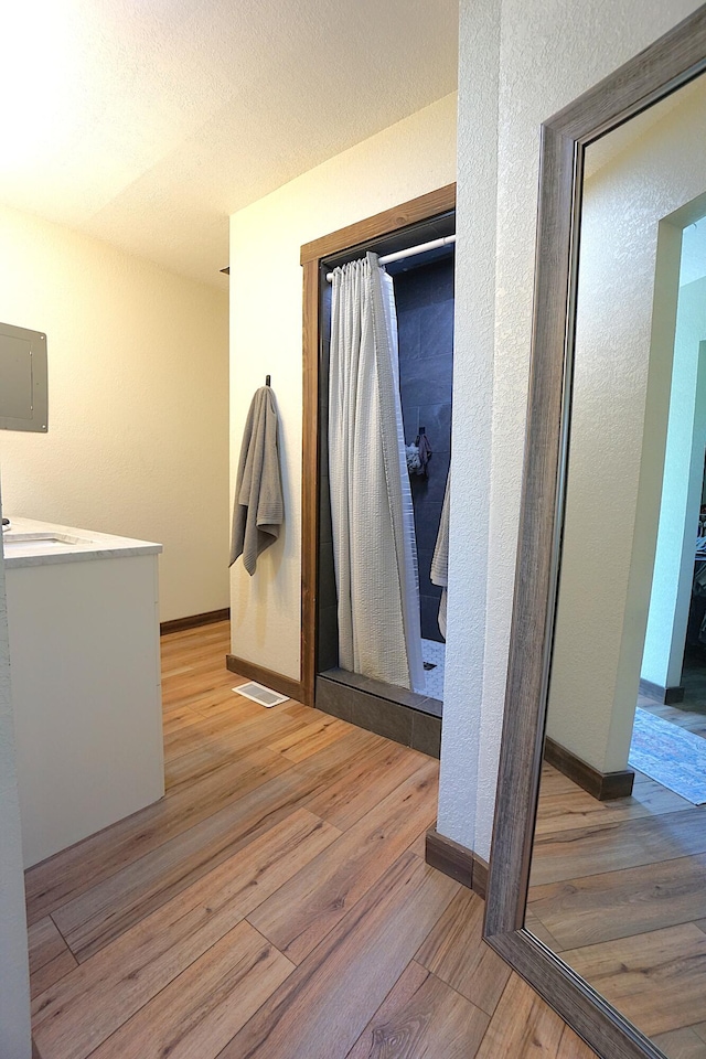 20770 State Highway 76, Cassville, MO 65625 - corridor featuring light wood-style floors, baseboards, a textured wall, and electric panel