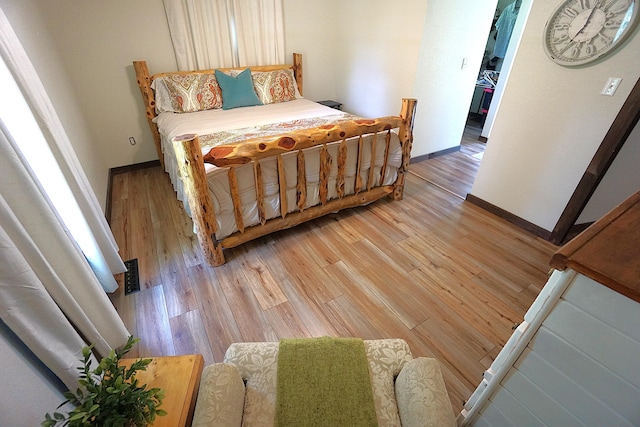 20770 State Highway 76, Cassville, MO 65625 - bedroom featuring light wood finished floors, baseboards, and a walk in closet