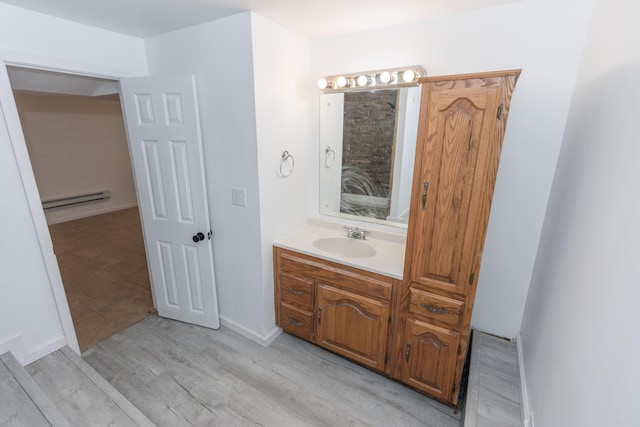 1204 S 11th St, Ozark, MO 65721 - bathroom featuring a baseboard radiator, vanity, wood finished floors, and baseboards