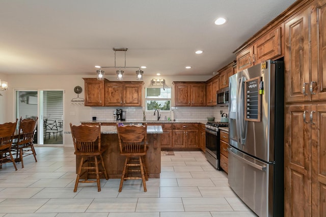 684 Spring Creek Rd, Clever, MO 65631 - kitchen with stainless steel appliances, brown cabinets, tasteful backsplash, a kitchen bar, and recessed lighting