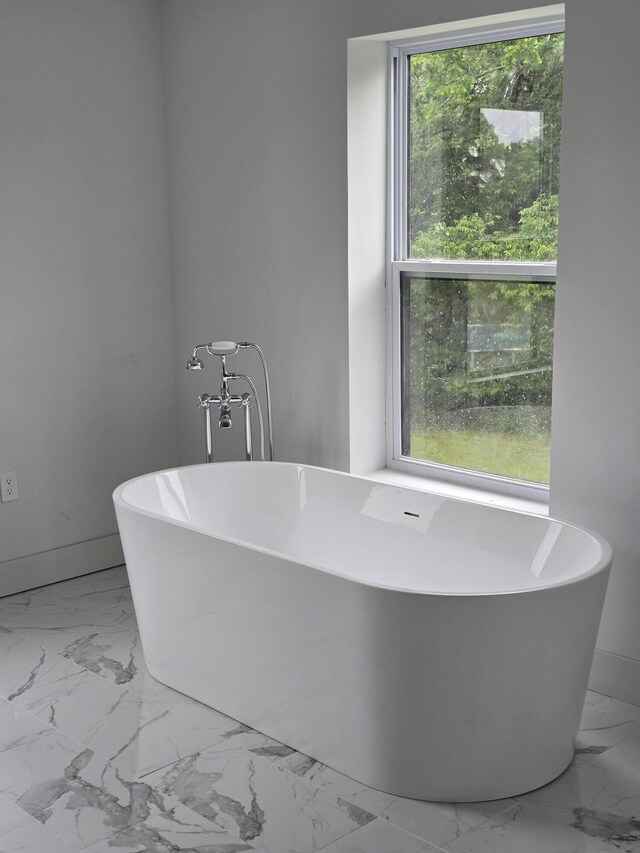 176 Shooting Star Ln, Nixa, MO 65714 - bathroom with marble look tiles, plenty of natural light, and a soaking tub