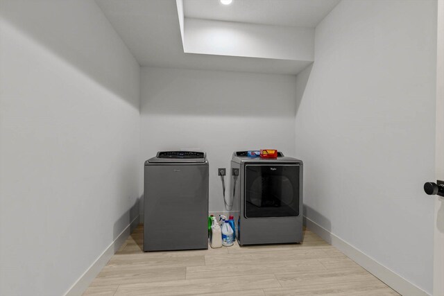 176 Shooting Star Ln, Nixa, MO 65714 - washroom featuring washer and clothes dryer, baseboards, and light wood-type flooring