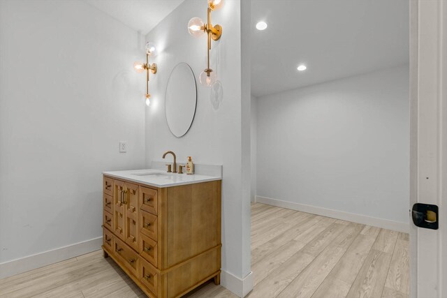 176 Shooting Star Ln, Nixa, MO 65714 - bathroom with wood finished floors, vanity, baseboards, and recessed lighting