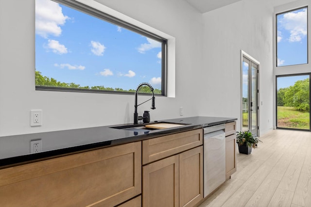 176 Shooting Star Ln, Nixa, MO 65714 - kitchen with a sink, stainless steel dishwasher, dark countertops, light wood-type flooring, and baseboards