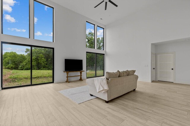 176 Shooting Star Ln, Nixa, MO 65714 - living room with a high ceiling, ceiling fan, light wood-style flooring, and baseboards