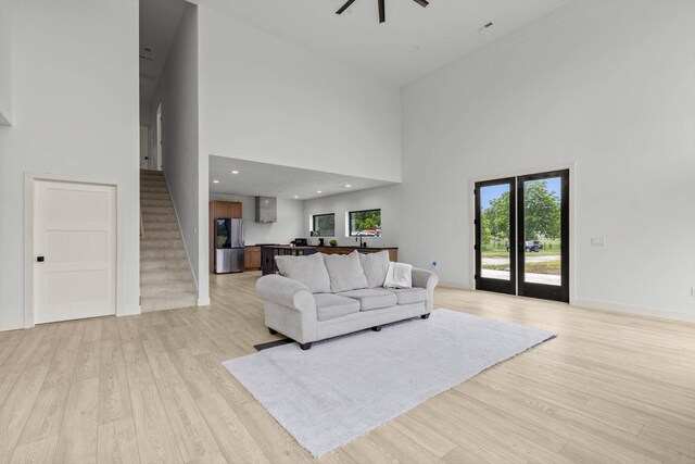 176 Shooting Star Ln, Nixa, MO 65714 - living area with a high ceiling, stairs, light wood-style flooring, and plenty of natural light
