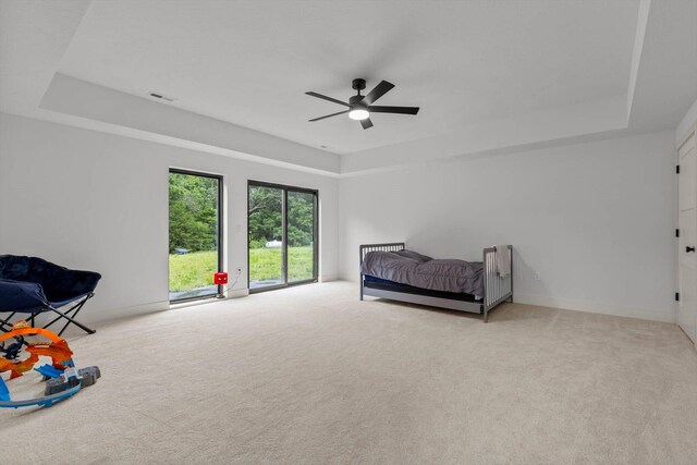 176 Shooting Star Ln, Nixa, MO 65714 - unfurnished bedroom with a tray ceiling, carpet, and ceiling fan