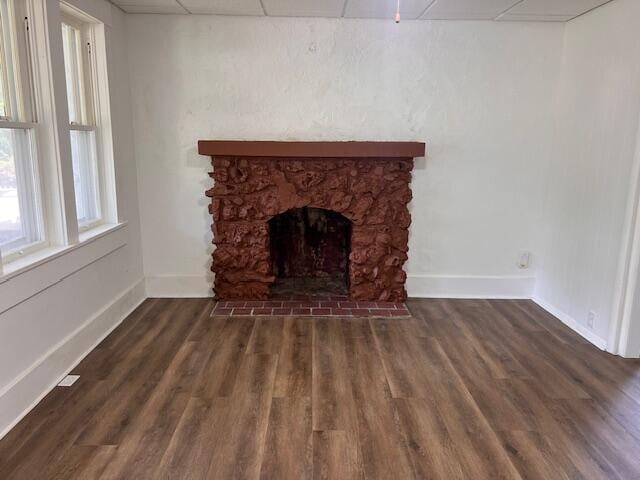 935 W Brower St, Springfield, MO 65802 - unfurnished living room with a paneled ceiling, baseboards, a fireplace, and wood finished floors