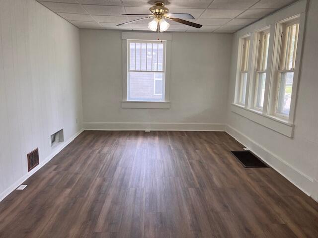935 W Brower St, Springfield, MO 65802 - empty room featuring a paneled ceiling, a ceiling fan, dark wood finished floors, and baseboards