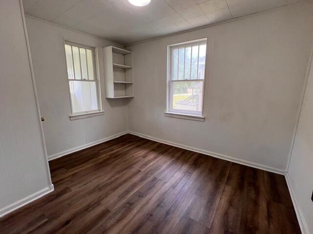 935 W Brower St, Springfield, MO 65802 - unfurnished room featuring dark wood finished floors, ornamental molding, and baseboards