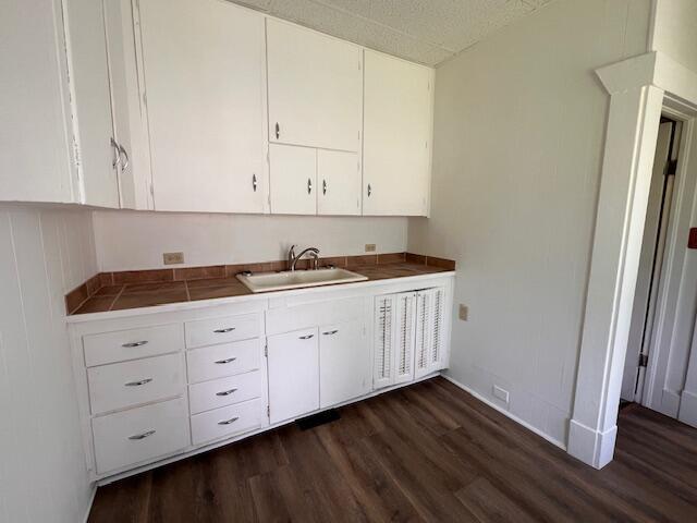 935 W Brower St, Springfield, MO 65802 - kitchen featuring a sink, dark wood-type flooring, tile counters, and white cabinetry