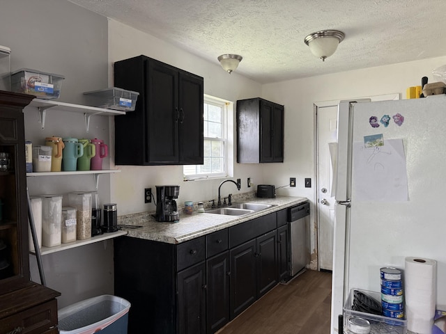 208 Justin St, Rogersville, MO 65742 - kitchen featuring freestanding refrigerator, stainless steel dishwasher, a sink, dark cabinets, and dark wood-style flooring