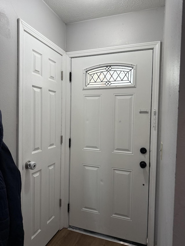 208 Justin St, Rogersville, MO 65742 - doorway to outside with dark wood-type flooring and a textured ceiling