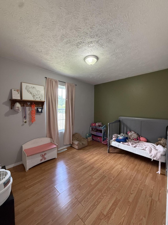 208 Justin St, Rogersville, MO 65742 - bedroom with light wood-style floors and a textured ceiling