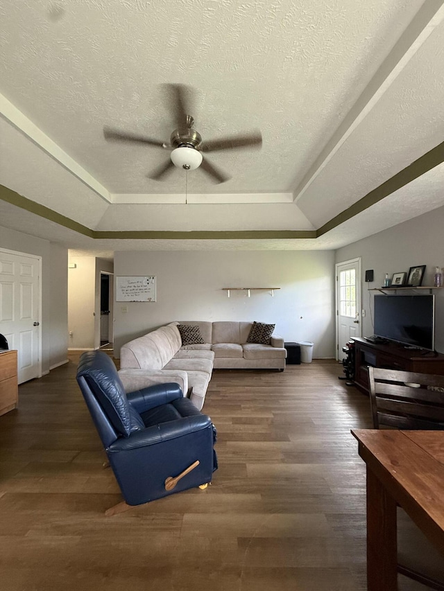 208 Justin St, Rogersville, MO 65742 - living area featuring a tray ceiling, a ceiling fan, wood finished floors, baseboards, and a textured ceiling