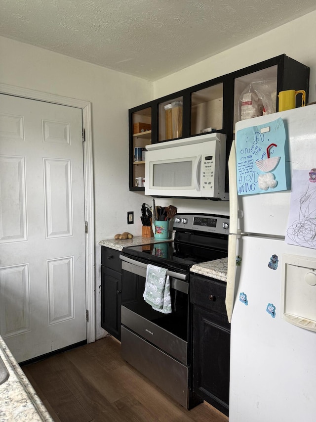 208 Justin St, Rogersville, MO 65742 - kitchen featuring white appliances, dark wood finished floors, light countertops, dark cabinets, and a textured ceiling
