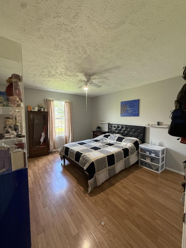 208 Justin St, Rogersville, MO 65742 - bedroom with a textured ceiling, wood finished floors, and a ceiling fan