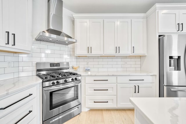 1674 N Marlowe Ave, Springfield, MO 65802 - kitchen featuring wall chimney exhaust hood, stainless steel appliances, white cabinets, and tasteful backsplash