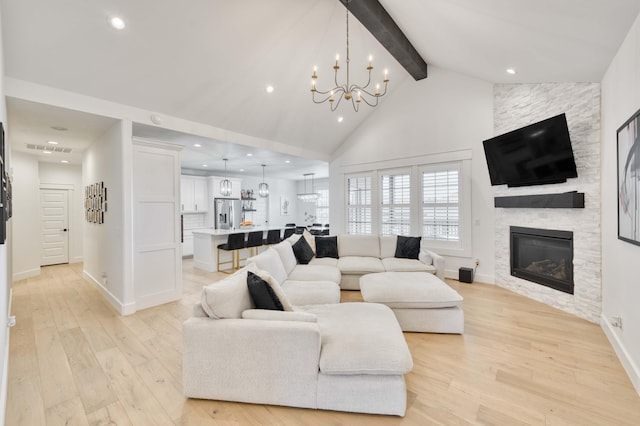1674 N Marlowe Ave, Springfield, MO 65802 - living room featuring beamed ceiling, a chandelier, light wood-style flooring, recessed lighting, and a stone fireplace