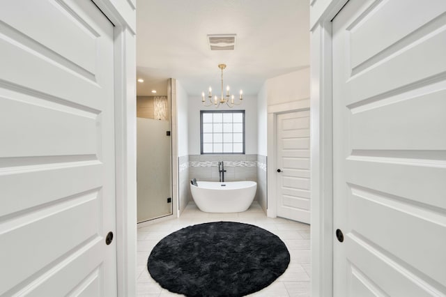 1674 N Marlowe Ave, Springfield, MO 65802 - bathroom featuring a chandelier, tile patterned floors, a freestanding tub, tile walls, and a stall shower