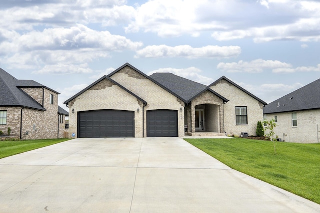 1674 N Marlowe Ave, Springfield, MO 65802 - french provincial home with brick siding, an attached garage, concrete driveway, and a front lawn