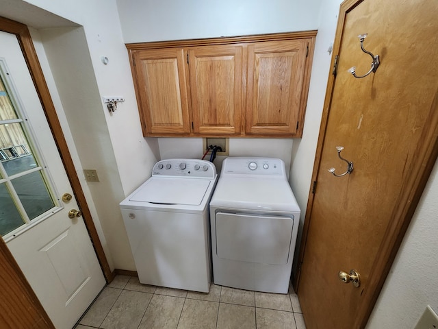 29039 Nottinghill Dr, Shell Knob, MO 65747 - washroom with washing machine and clothes dryer, cabinet space, and light tile patterned floors