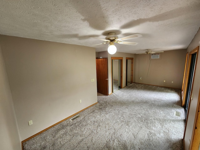 29039 Nottinghill Dr, Shell Knob, MO 65747 - empty room with a ceiling fan, carpet, a wall mounted AC, and a textured ceiling