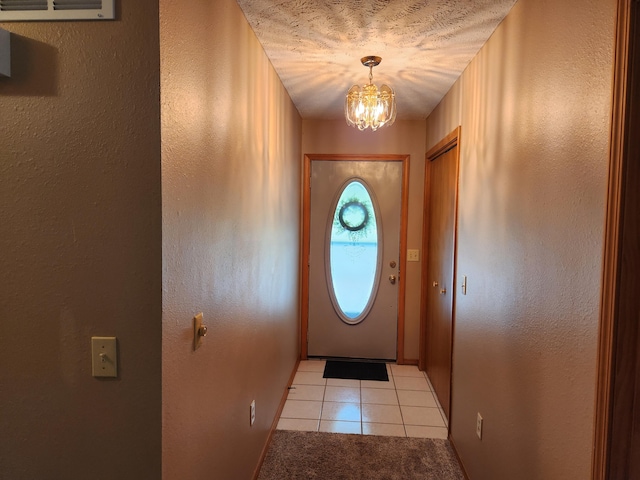 29039 Nottinghill Dr, Shell Knob, MO 65747 - entryway featuring light tile patterned floors, a chandelier, and a textured wall