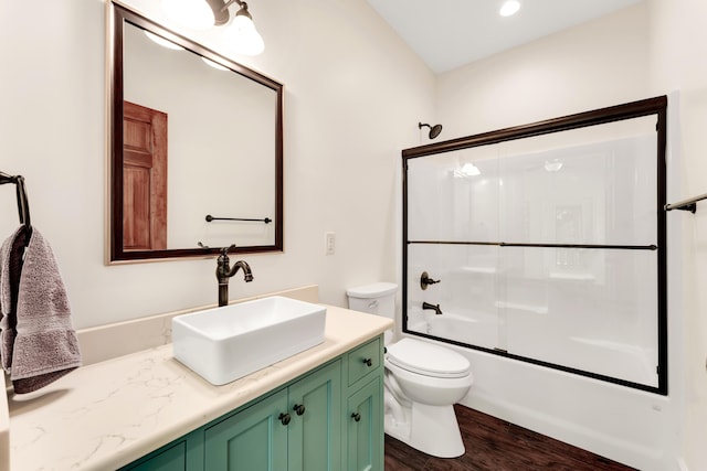 2029 Moon Valley Rd, Ozark, MO 65721 - bathroom featuring toilet, vanity, wood finished floors, and shower / bath combination with glass door