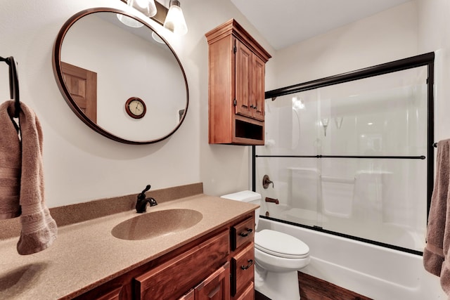 2029 Moon Valley Rd, Ozark, MO 65721 - full bathroom with toilet, vanity, shower / bath combination with glass door, and wood finished floors