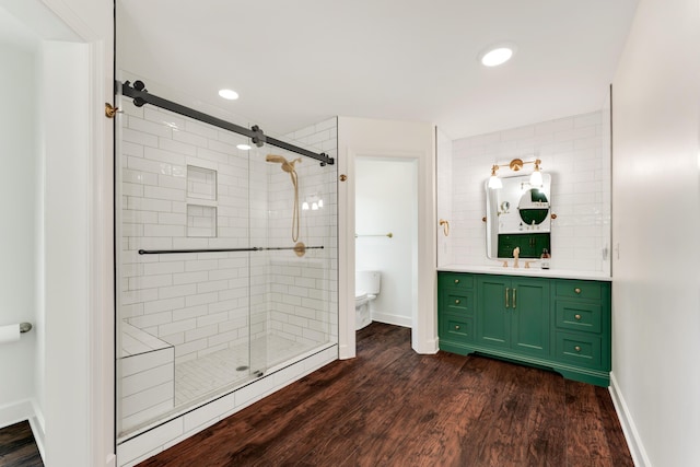 2029 Moon Valley Rd, Ozark, MO 65721 - bathroom featuring a shower stall, vanity, wood finished floors, baseboards, and toilet
