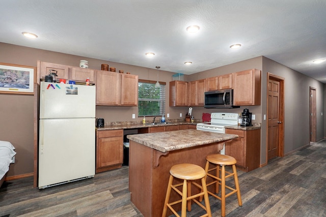 123 Fossil Cove Rd, Cape Fair, MO 65624 - kitchen with white appliances, dark wood finished floors, a kitchen bar, a kitchen island, and light countertops