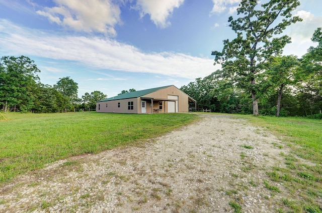 123 Fossil Cove Rd, Cape Fair, MO 65624 - view of yard with a garage, driveway, an outbuilding, and a pole building