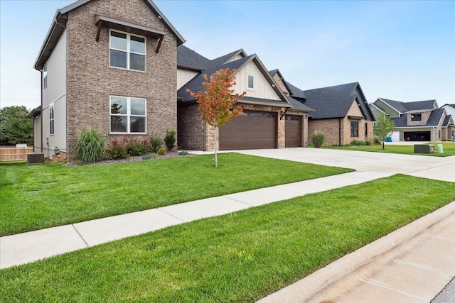 4943 S Aaron Ave, Springfield, MO 65810 - view of front facade featuring driveway, a front lawn, an attached garage, and brick siding