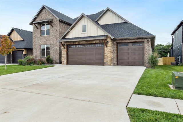 4943 S Aaron Ave, Springfield, MO 65810 - view of front of house with board and batten siding, concrete driveway, roof with shingles, an attached garage, and a front yard