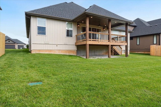 4943 S Aaron Ave, Springfield, MO 65810 - back of property featuring a ceiling fan, a shingled roof, a deck, stairs, and a lawn