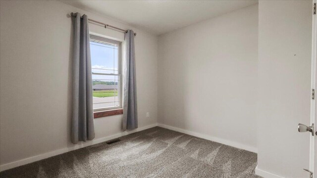2606 Country Dr, Mountain Grove, MO 65711 - spare room featuring carpet flooring and baseboards