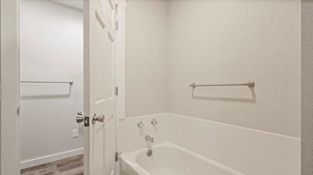 2606 Country Dr, Mountain Grove, MO 65711 - full bathroom with a garden tub, baseboards, and wood finished floors