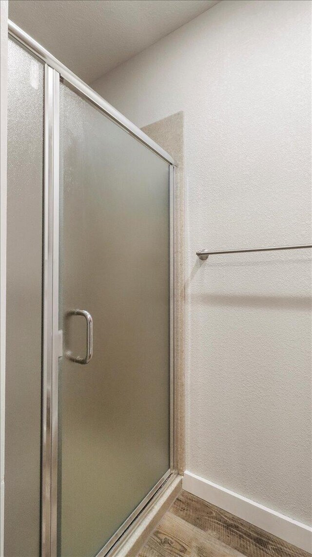 2606 Country Dr, Mountain Grove, MO 65711 - full bath with a stall shower, baseboards, and wood finished floors