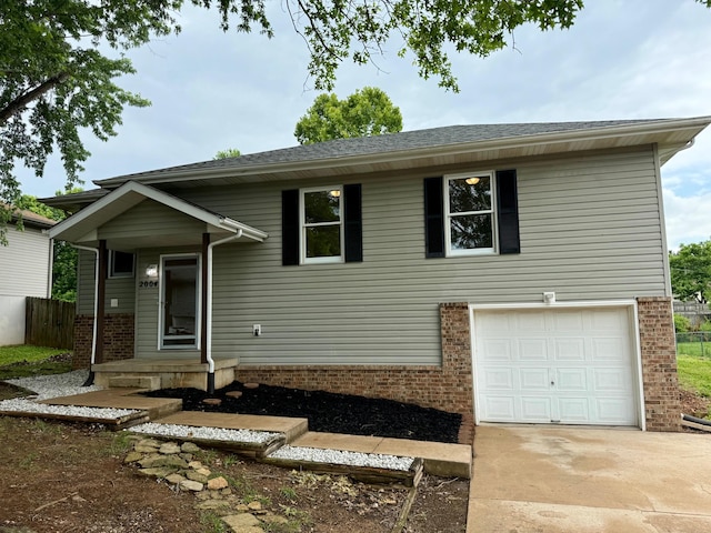 2004 S 16th St, Ozark, MO 65721 - view of front of house featuring a garage, concrete driveway, and brick siding