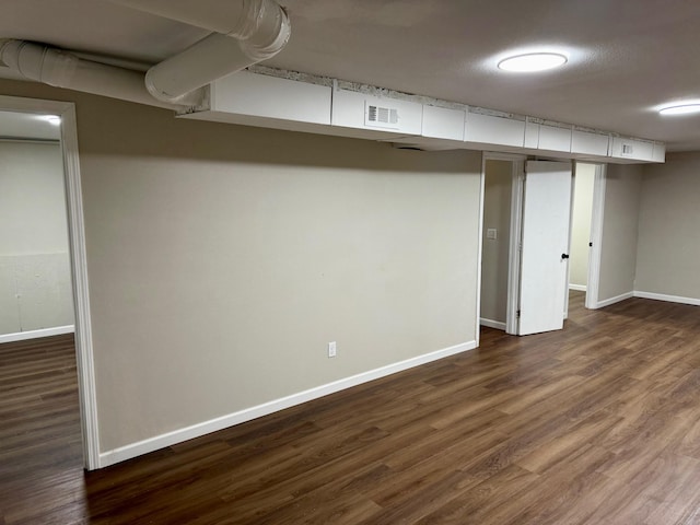 2004 S 16th St, Ozark, MO 65721 - finished basement featuring dark wood-style flooring and baseboards