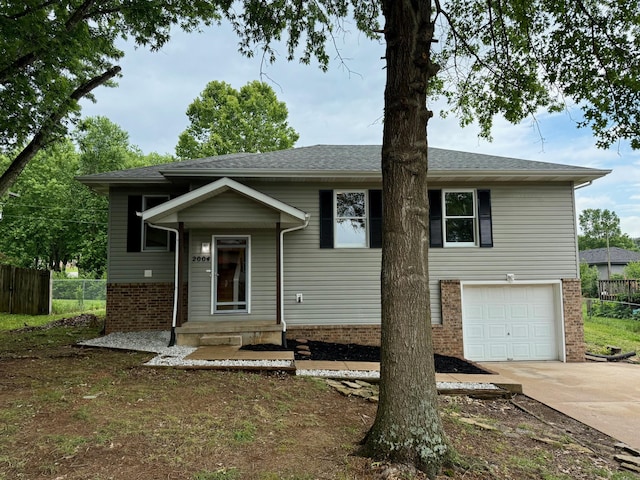 2004 S 16th St, Ozark, MO 65721 - view of front of home with brick siding, concrete driveway, and a garage