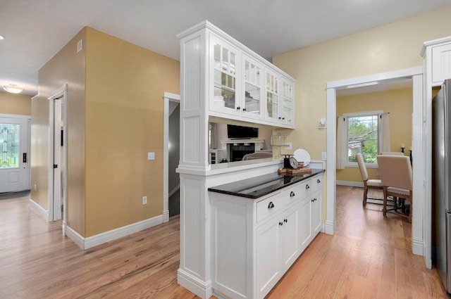 401 E Glendale St, Aurora, MO 65605 - kitchen featuring light wood-type flooring, white cabinetry, glass insert cabinets, and baseboards