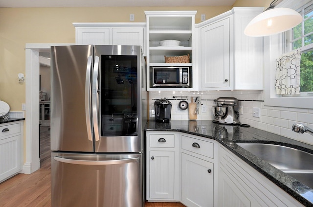 401 E Glendale St, Aurora, MO 65605 - kitchen featuring appliances with stainless steel finishes, a sink, decorative backsplash, white cabinetry, and light wood-style flooring