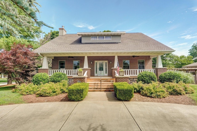 401 E Glendale St, Aurora, MO 65605 - view of front of property featuring covered porch, brick siding, a chimney, and roof with shingles