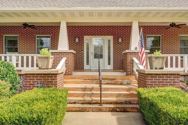 401 E Glendale St, Aurora, MO 65605 - view of exterior entry featuring ceiling fan, brick siding, roof with shingles, and covered porch