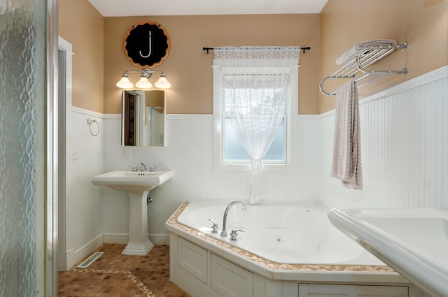 401 E Glendale St, Aurora, MO 65605 - full bath with a wainscoted wall, a jetted tub, a sink, and tile patterned flooring